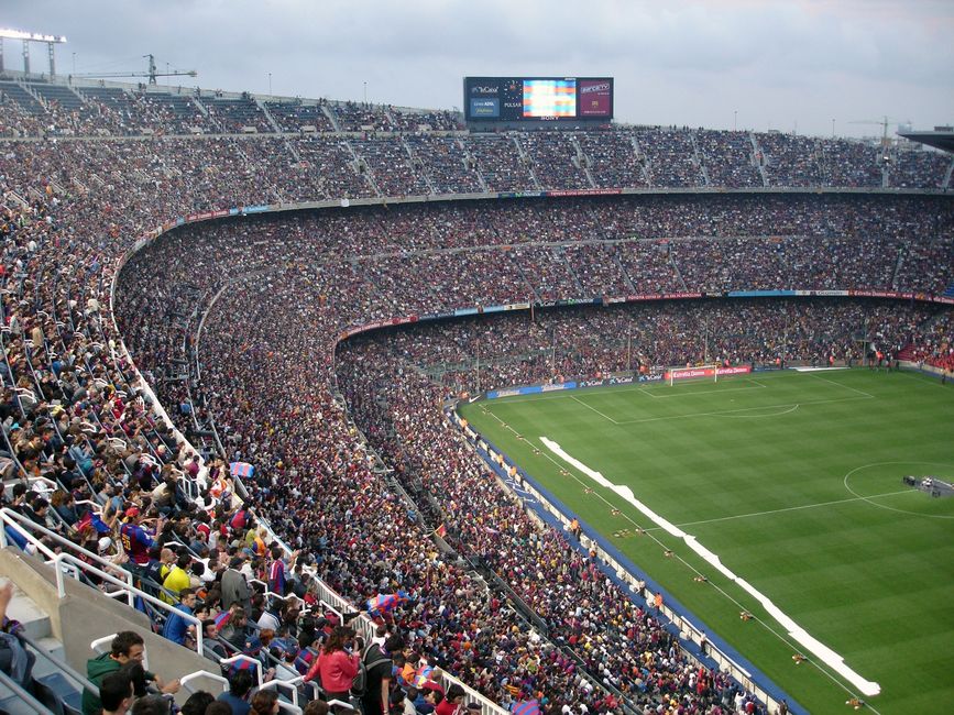 Un estadio lleno de aficionados entusiastas viendo un emocionante partido de fútbol.